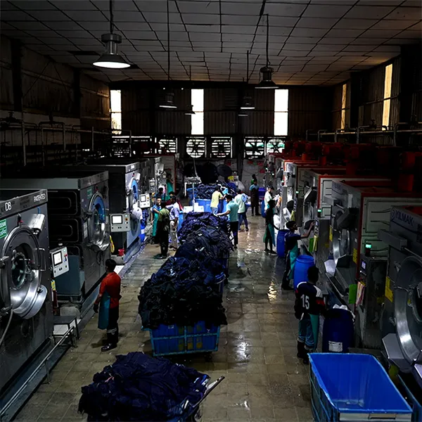 People working on industrial washing machines