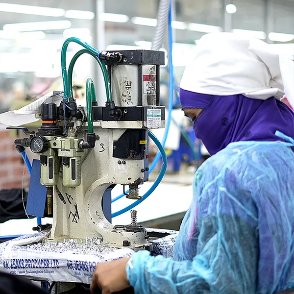 Person working on industrial machine and ensuring garment quality