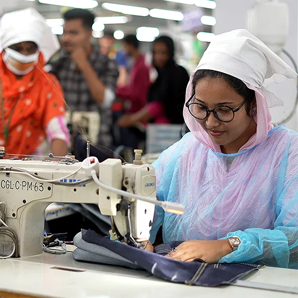 Person on sewing machine ensuring garment quality
